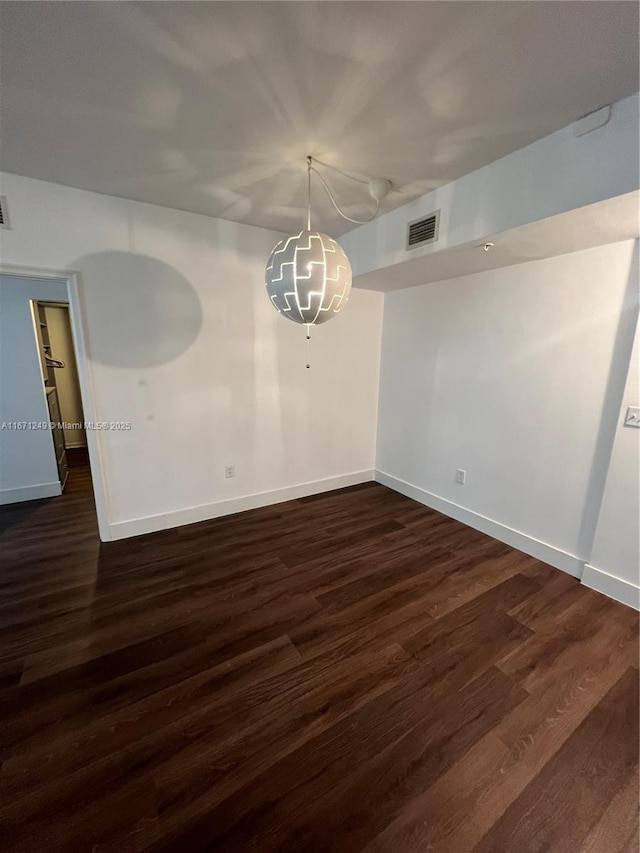 unfurnished room with dark hardwood / wood-style floors