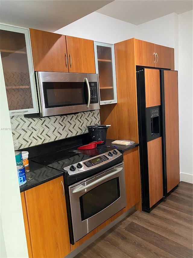 kitchen featuring dark wood-type flooring and appliances with stainless steel finishes