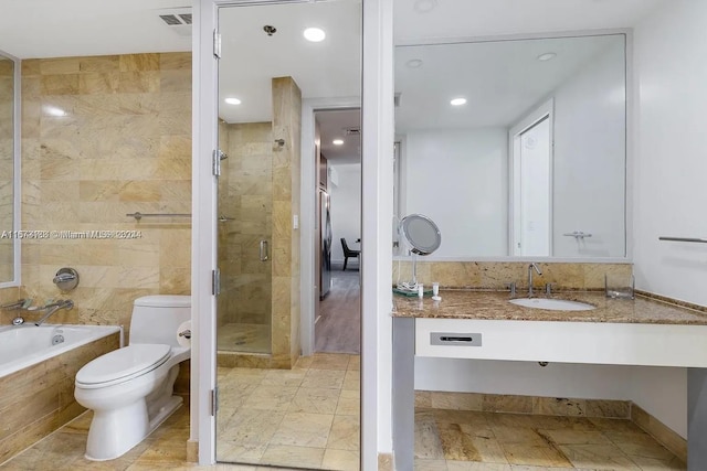 full bathroom featuring independent shower and bath, vanity, and toilet