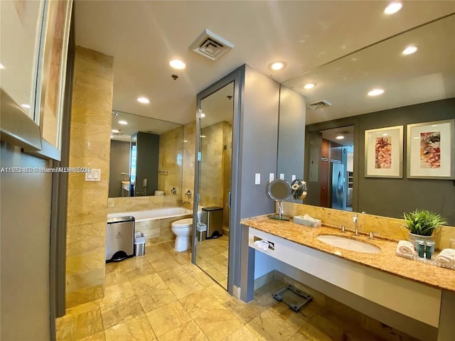 bathroom with washer / clothes dryer, vanity, and toilet