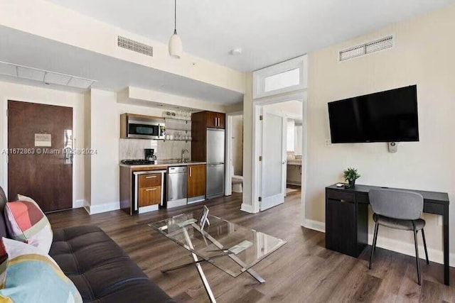 living room featuring dark wood-type flooring and sink