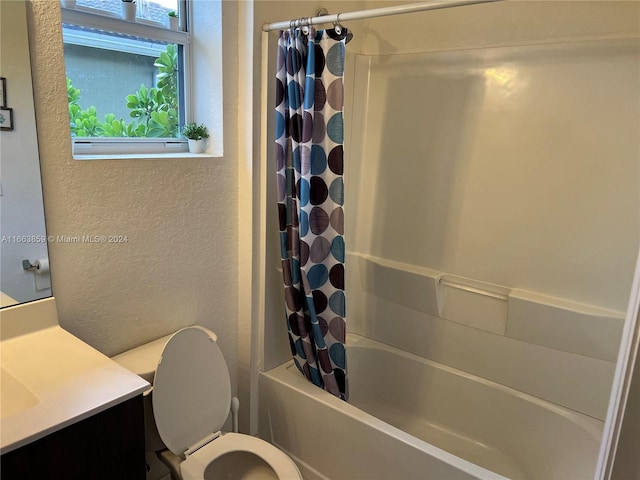 full bathroom with shower / bathtub combination with curtain, vanity, and toilet