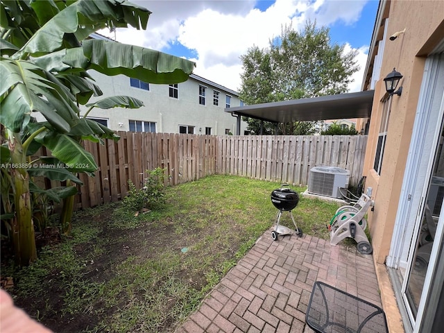 view of yard featuring a patio and central AC