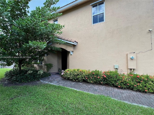 view of side of home with a lawn