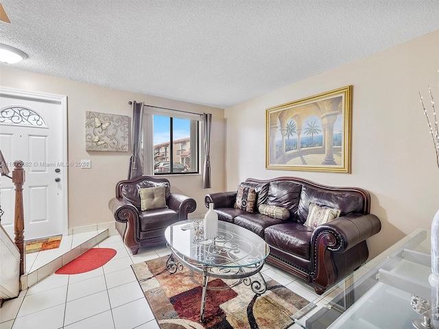 living room featuring light tile patterned floors and a textured ceiling