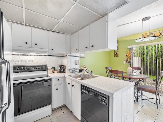 kitchen with white cabinets, decorative light fixtures, sink, and white appliances