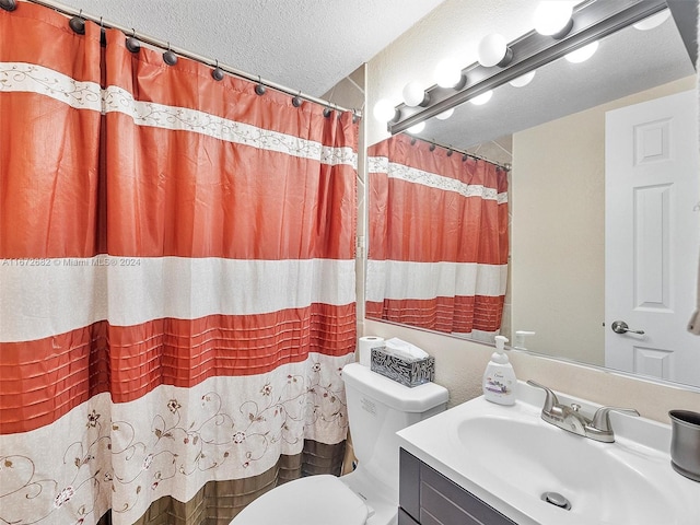 bathroom featuring a shower with curtain, vanity, toilet, and a textured ceiling