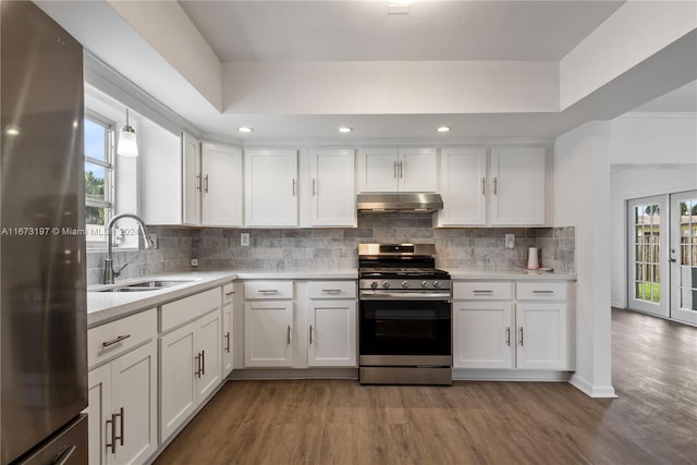 kitchen with tasteful backsplash, white cabinetry, and appliances with stainless steel finishes