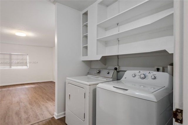 washroom featuring dark hardwood / wood-style flooring and washing machine and clothes dryer