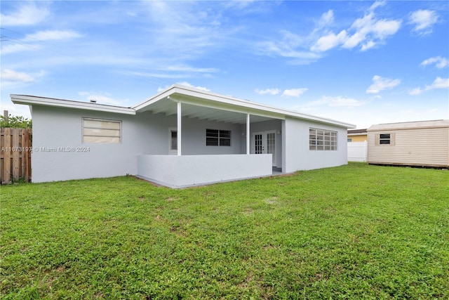 back of property featuring a yard