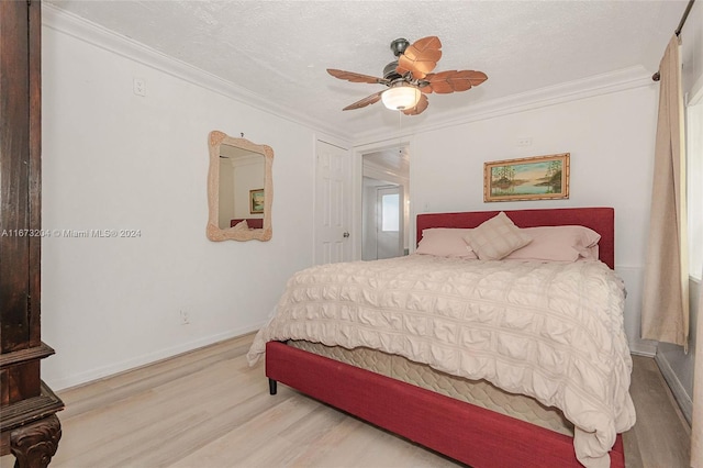 bedroom with crown molding, ceiling fan, hardwood / wood-style floors, and a textured ceiling