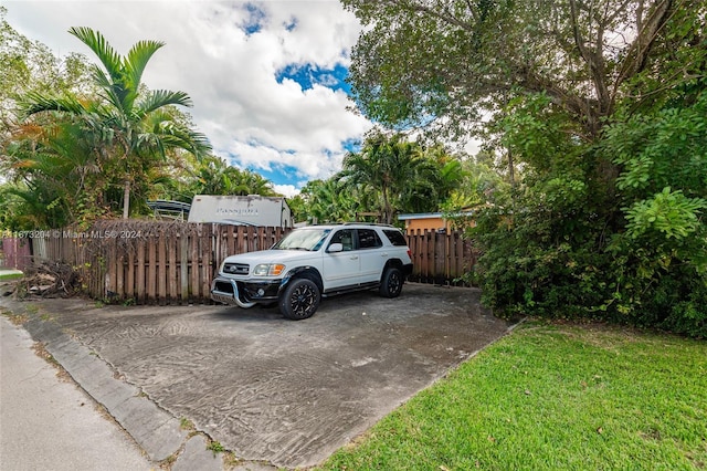 view of car parking with a yard