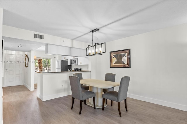 dining space featuring wood-type flooring