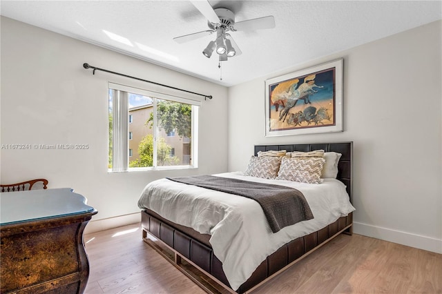 bedroom featuring ceiling fan and hardwood / wood-style flooring