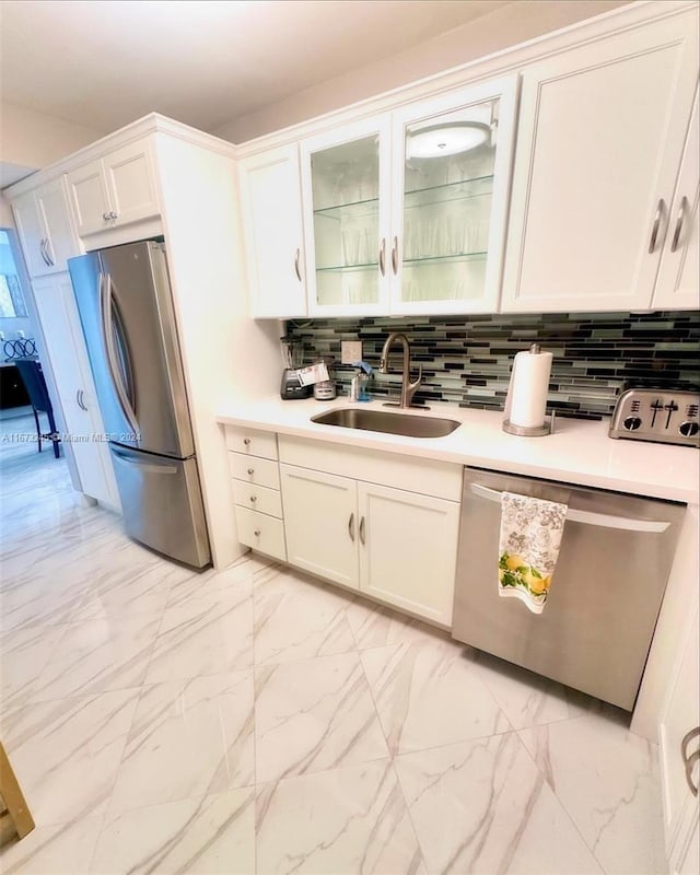 kitchen with white cabinetry, sink, appliances with stainless steel finishes, and tasteful backsplash