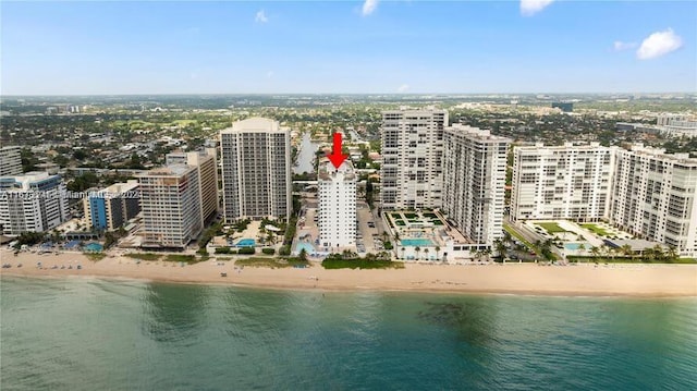 aerial view with a water view and a beach view