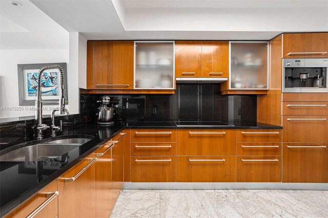 kitchen with dark stone counters, oven, black cooktop, and decorative backsplash