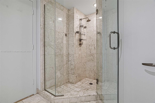 bathroom with a shower with shower door