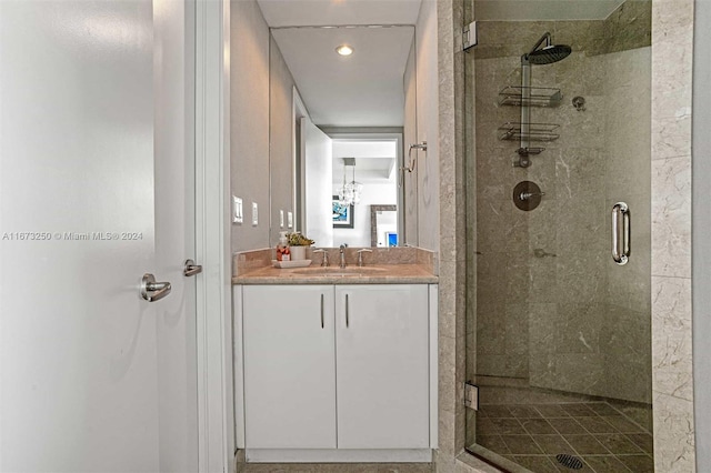 bathroom featuring walk in shower and vanity