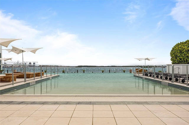 view of swimming pool with a water view