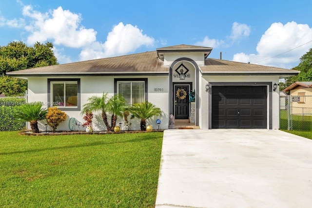 view of front of house with a front yard and a garage