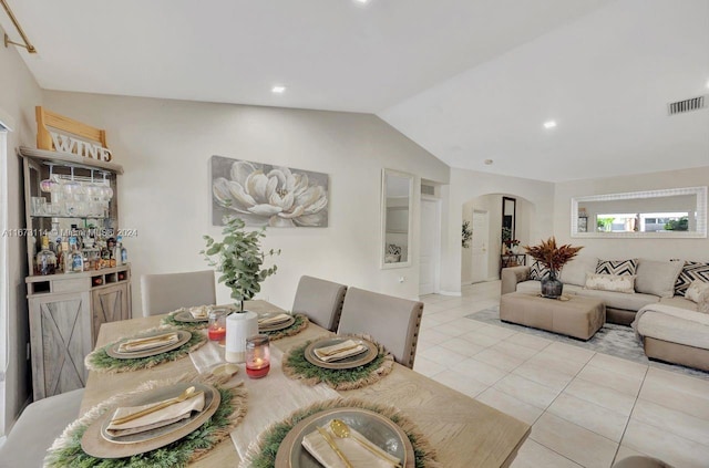 tiled dining room with vaulted ceiling