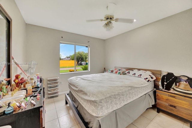 tiled bedroom featuring ceiling fan