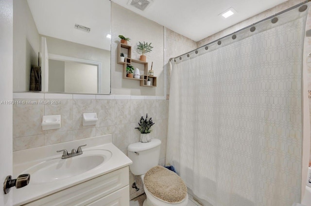 full bathroom featuring vanity, tile walls, shower / bath combo, and toilet