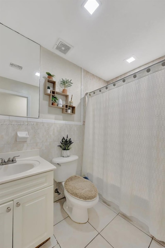 full bathroom featuring toilet, tile patterned flooring, shower / bath combination with curtain, tile walls, and vanity