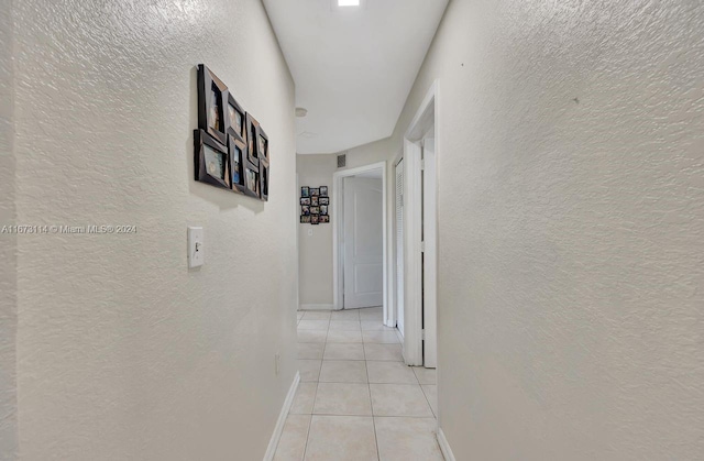 hall with light tile patterned floors