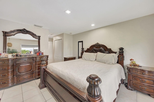 bedroom with a closet and light tile patterned flooring