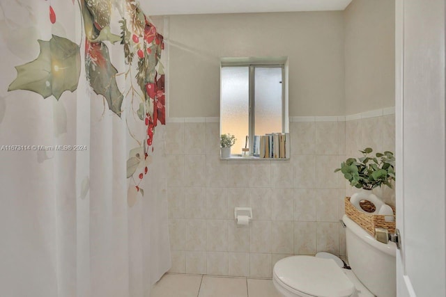 bathroom featuring toilet, tile walls, walk in shower, and tile patterned flooring