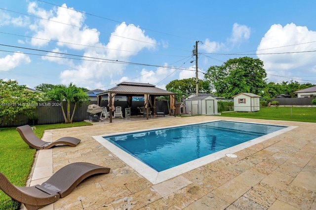 view of pool with a gazebo, a patio area, a storage unit, and a yard