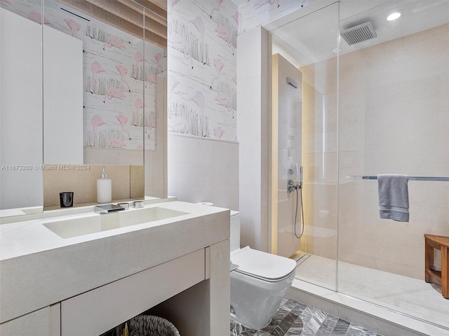 bathroom featuring tile walls, vanity, a shower with shower door, and toilet