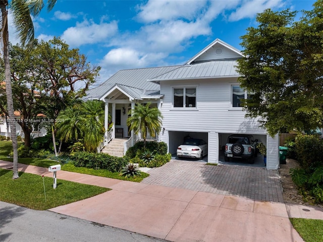 view of front of property with a garage and a carport