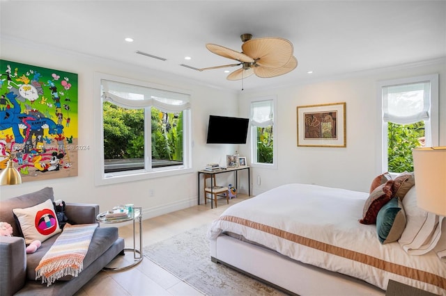 bedroom with multiple windows, ceiling fan, crown molding, and light hardwood / wood-style flooring