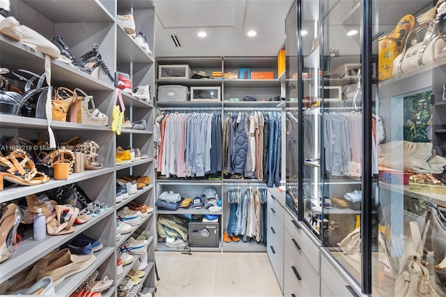 spacious closet featuring light hardwood / wood-style floors