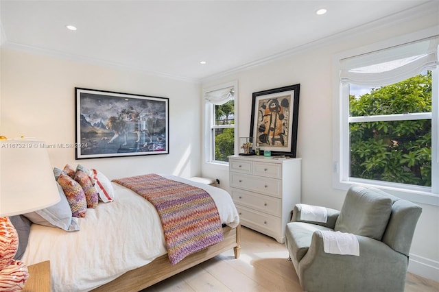 bedroom featuring crown molding and light wood-type flooring