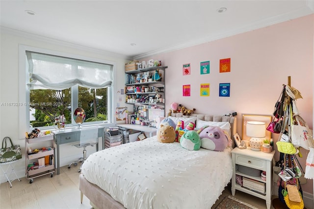 bedroom with ornamental molding and light wood-type flooring