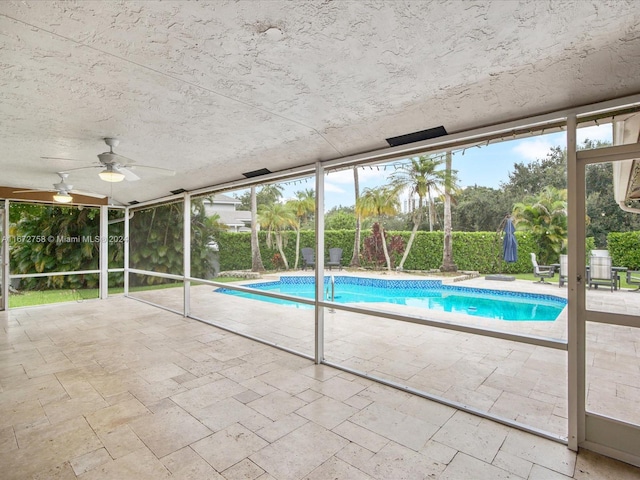 view of swimming pool with ceiling fan and a patio area