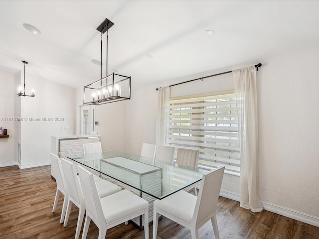 dining area featuring a notable chandelier and hardwood / wood-style flooring