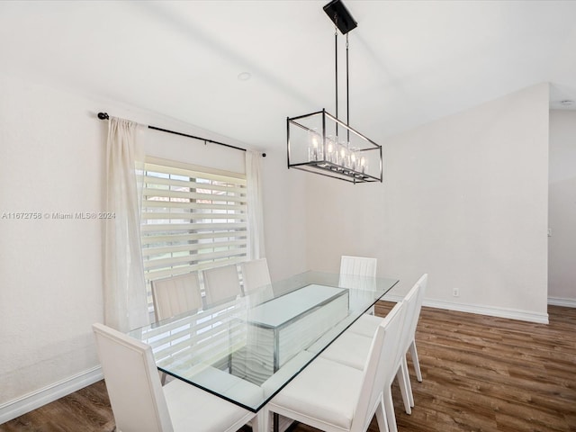 dining room with an inviting chandelier and dark hardwood / wood-style floors