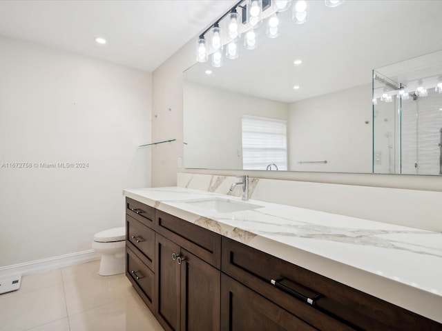 bathroom with tile patterned flooring, a shower with door, vanity, and toilet