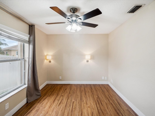 unfurnished room featuring ceiling fan and hardwood / wood-style floors