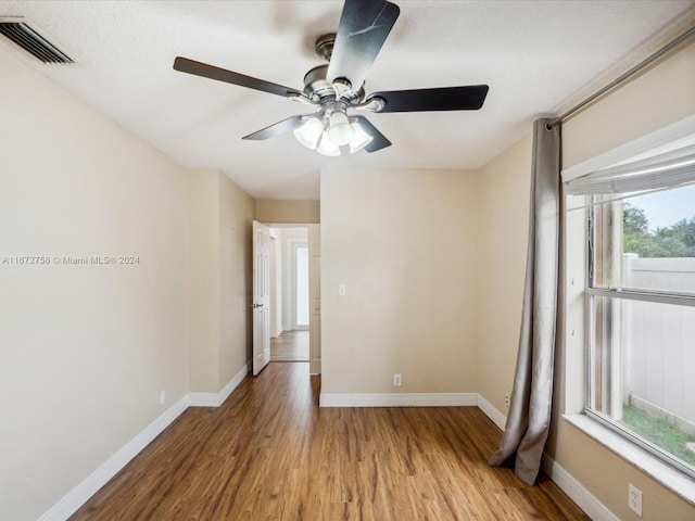 empty room featuring ceiling fan and hardwood / wood-style flooring