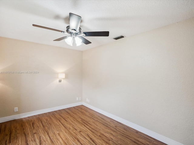 spare room with ceiling fan and hardwood / wood-style flooring