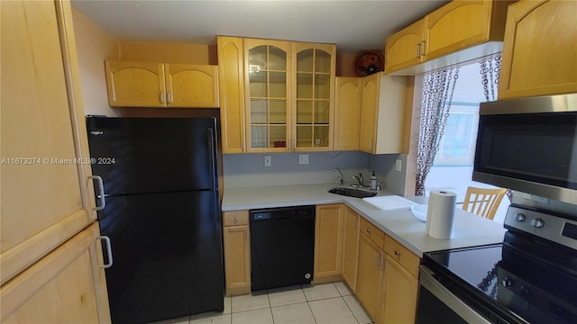 kitchen featuring light brown cabinets, light tile patterned floors, black appliances, and sink