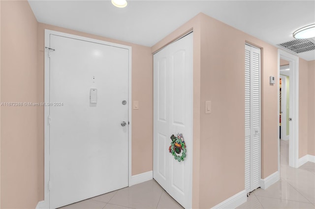 entryway featuring light tile patterned floors