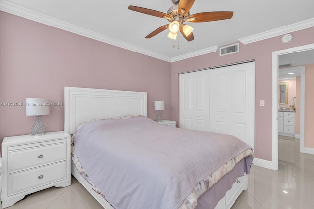 tiled bedroom with crown molding, ceiling fan, and a closet