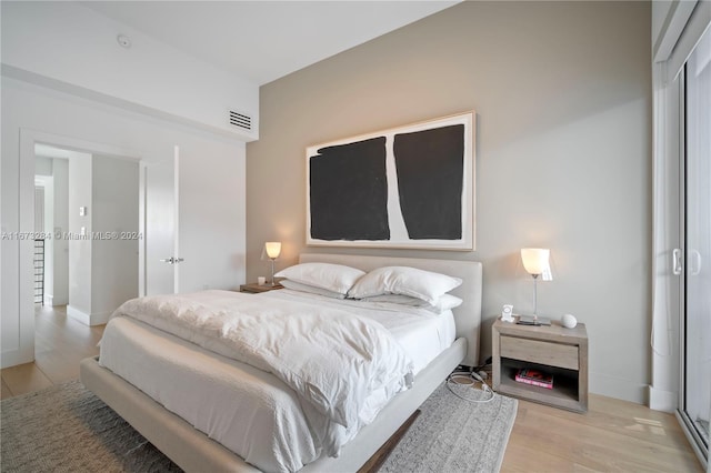 bedroom with a closet and light hardwood / wood-style flooring